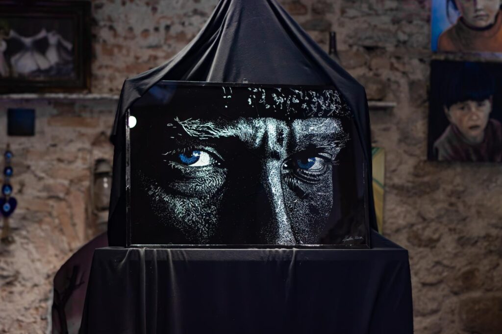Atatürk portrait in broken glass, half veiled before its unveiling