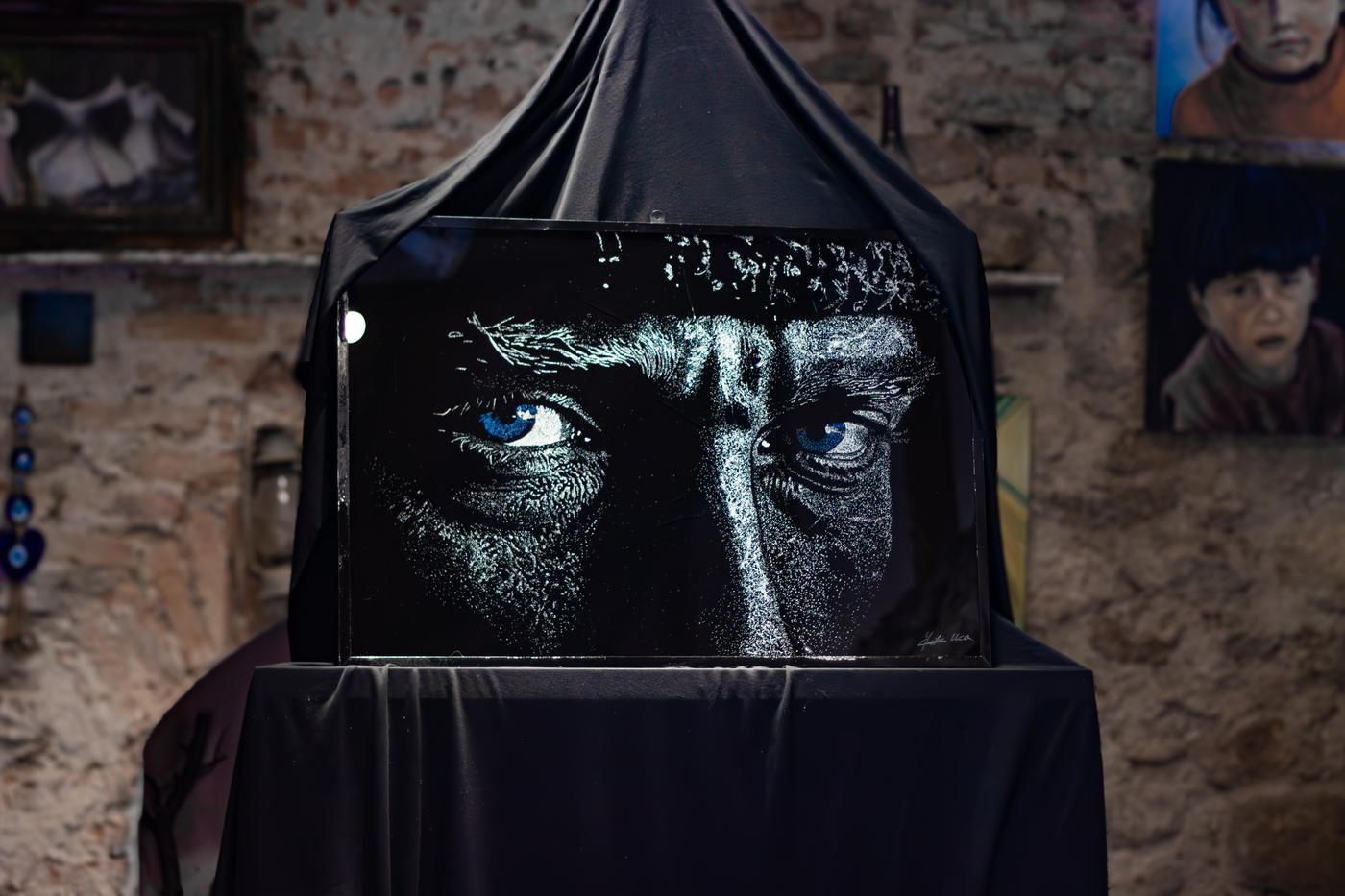 Atatürk portrait in broken glass, half veiled before its unveiling