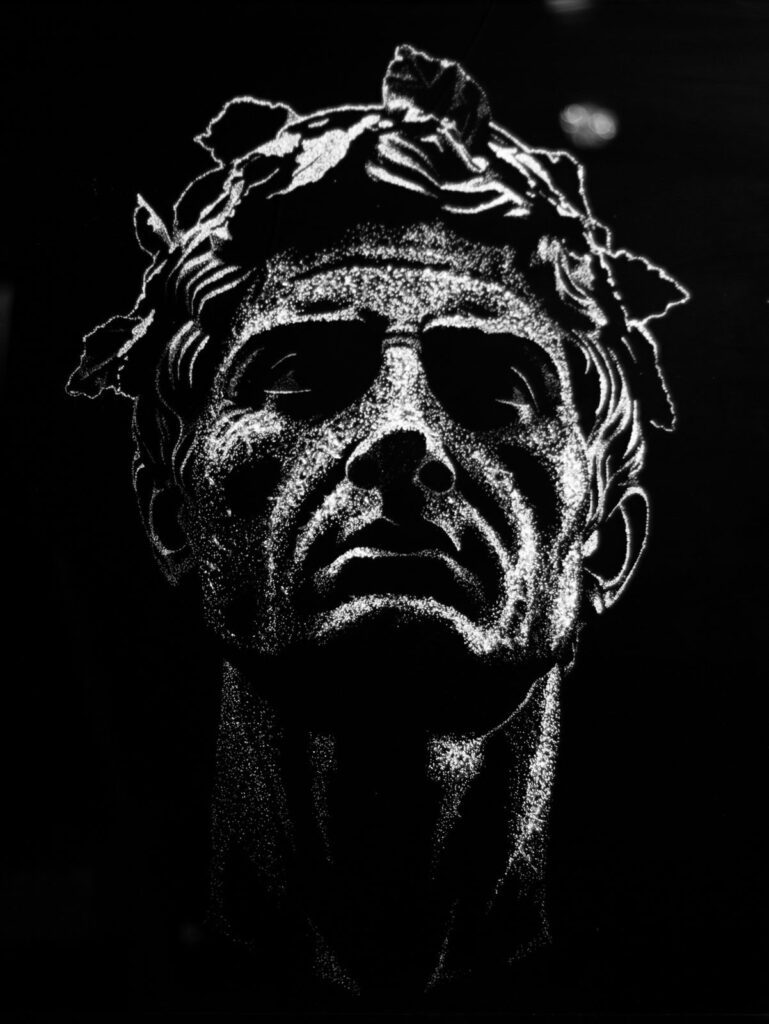 Caesar — a laurel-crowned head in fractured glass