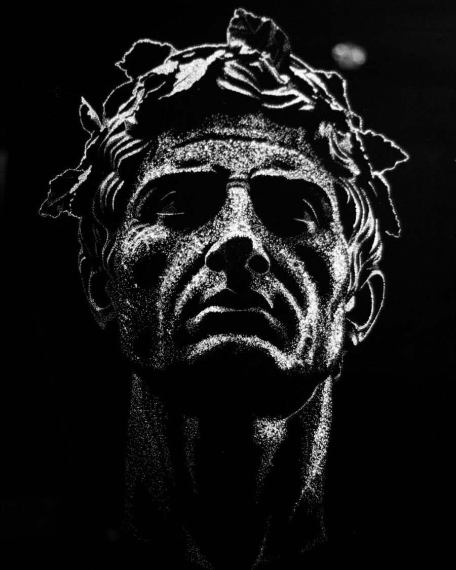 Caesar — a laurel-crowned head in fractured glass