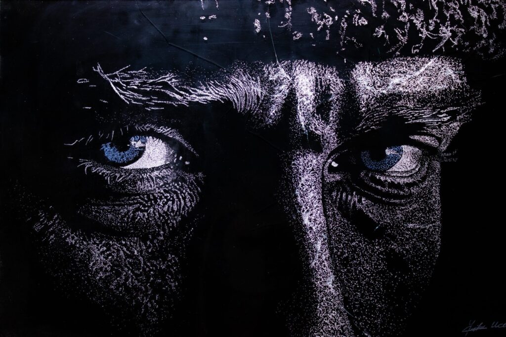 Close-up of a commissioned broken glass portrait: a man’s eyes
