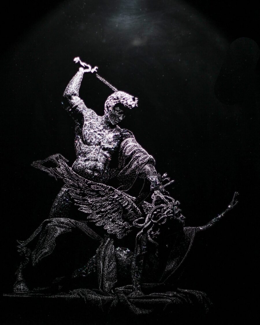 Perseus and Medusa — the hero raising a sword, in fractured glass