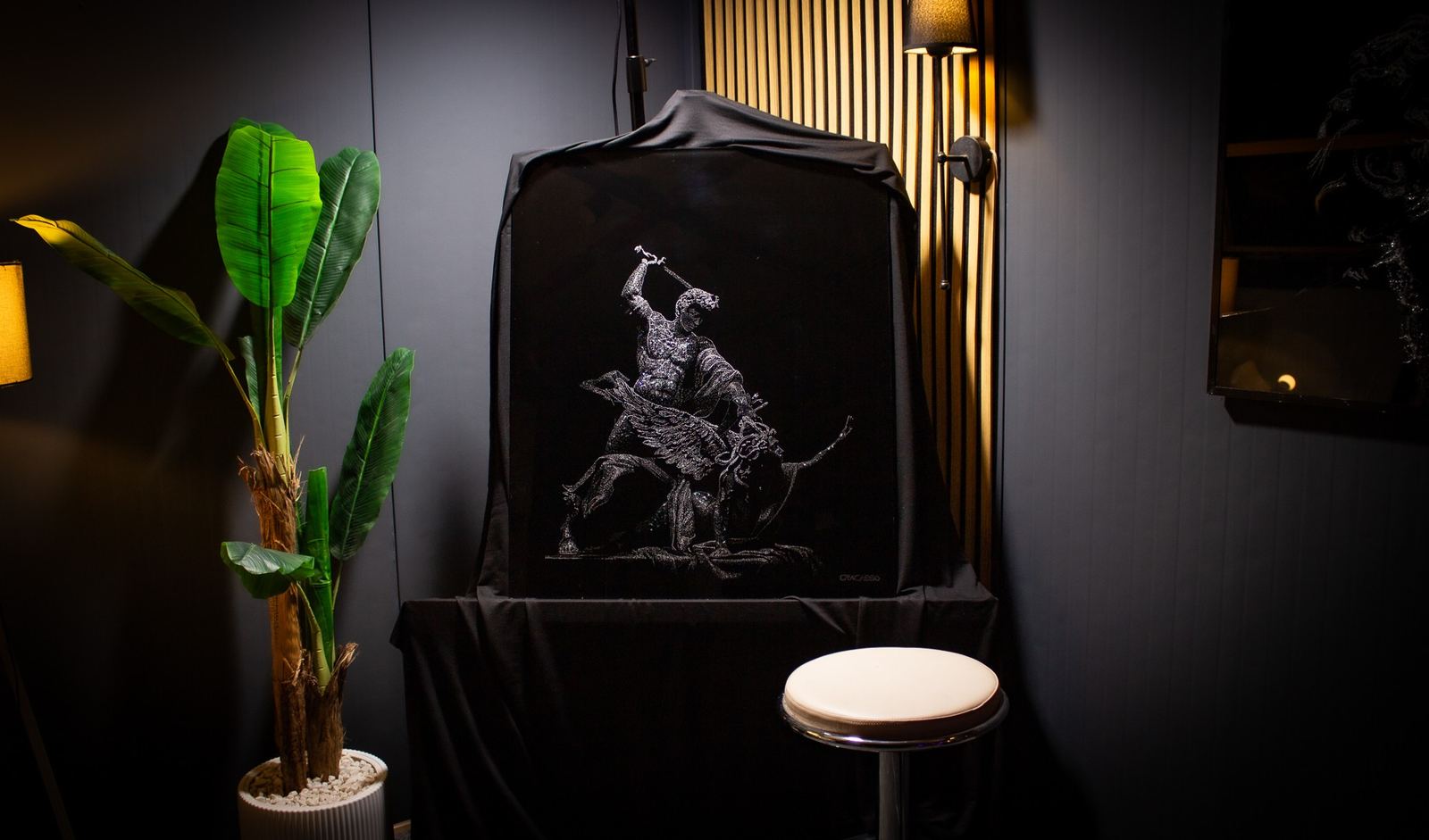 Perseus and Medusa displayed in a softly lit room