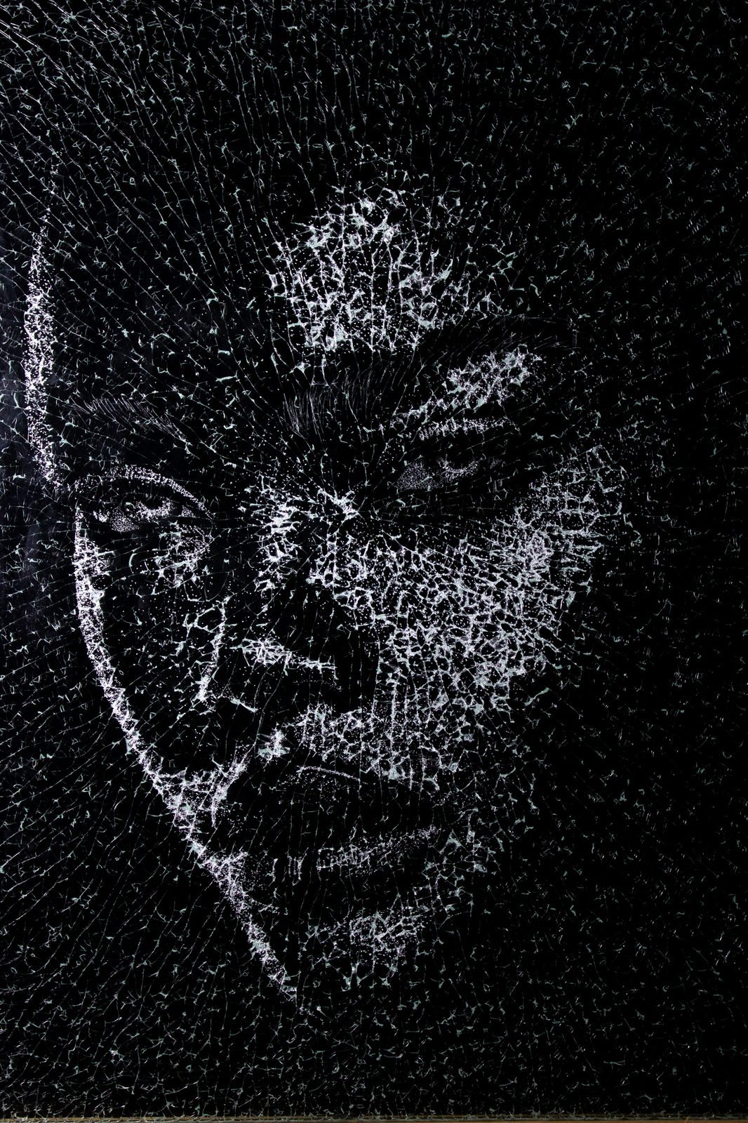 Sadie — a woman’s face drawn in white fractures on black-backed glass